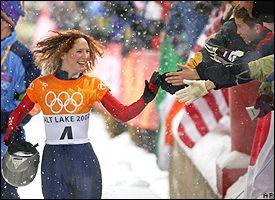 Tristan celebrates with fans after securing the gold in the Women's Skeleton Olympic event