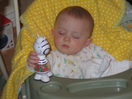 Ryan asleep in swing holding toy